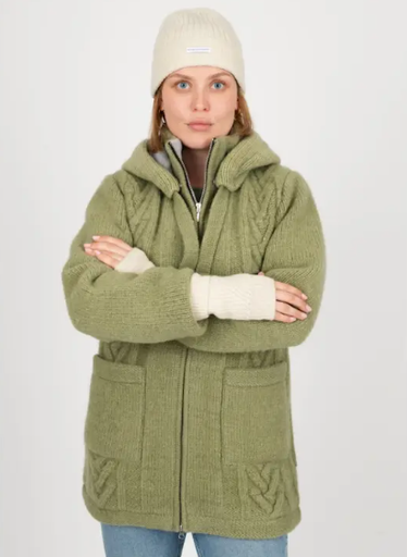 Frau in lindgrünem Wollmantel mit Zopfmuster